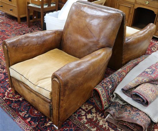 A pair of 1940s French tan leather armchairs, W.2ft 10in. D.3ft 1in. H.2ft 9in.